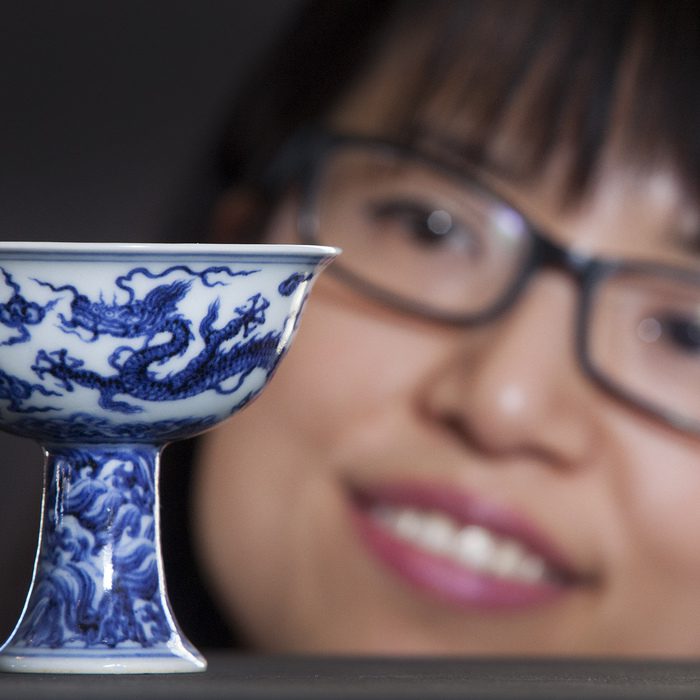 FILE PICTURE - Ling Zhu with a 600-year-old china cup valued in excess of £4 million which is set to go up for sale at a special auction by Lyon & Turnbull. The Ming stem cup, that dates back to around 1425, is the star lot of a specially curated sale of Chinese works of art in Hong Kong on May 31. Feb 10 2016. A rare Chinese cup that was kept in an unlocked university cupboard for 30 years after being dismissed as a "dusty old pot" is set to fetch a staggering £4 MILLION at auction. See NTI story NTICUP. The four-inch tall vessel was put into storage and forgotten about at Staffordshire University after being donated during the Second World War. But during a clear-out last year staff noticed the cup in an unlocked corridor on the campus and decided to investigate further. And boffins were left stunned when it turned out blue and white Stem Cup which is thought to have been made for an emperor during the Ming dynasty in 1425. It was part of a collection of more than 270 pieces which was donated to Staffordshire University during World War Two by London pharmacist Ernest Thornhill.